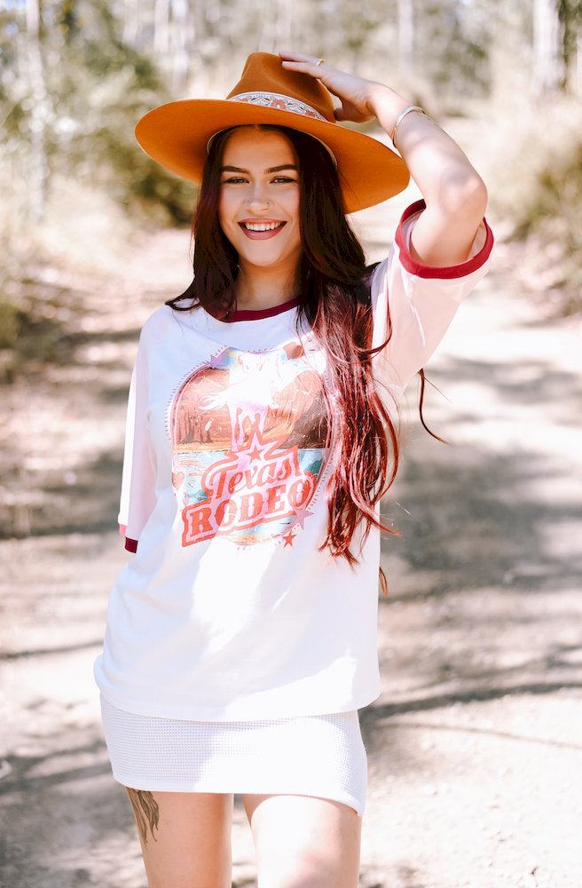 White Texas Rodeo Tee styled with a relaxed fit, short sleeves and vintage western-inspired print.