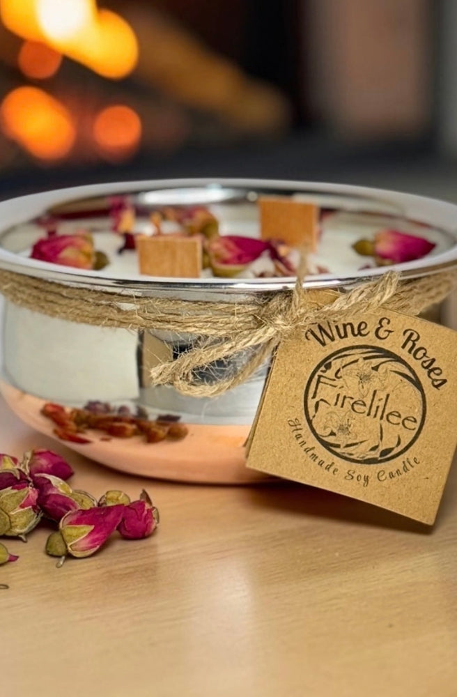 Wine & Roses Soy Candle in a silver bowl with dried rosebuds and botanical accents.